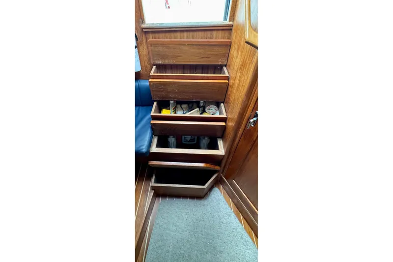 Slide: The Image of Wooden storage drawers inside a 2004 Topaz 32 Express boat cabin. - 35