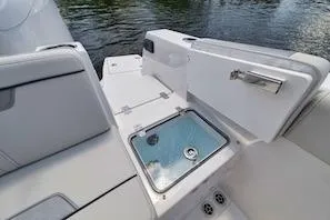 Slide: The Image of 2027 Sailfish 252 CC boat interior with seating and storage compartments on water. - 10