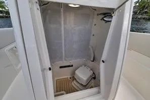 Slide: The Image of 2027 Sailfish 252 CC boat interior with compact marine toilet. - 15