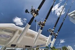 Slide: The Image of Fishing rods on a 2027 Sailfish 252 CC boat under a clear blue sky. - 17