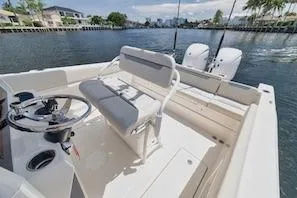 Slide: The Image of 2027 Sailfish 252 CC boat interior with dual engines on a scenic waterway. - 7