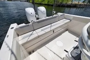 Slide: The Image of 2027 Sailfish 252 CC boat with dual engines, spacious seating, and sleek design on water. - 8