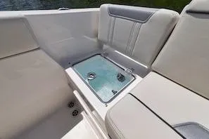 Slide: The Image of 2027 Sailfish 252 CC boat interior with cushioned seating and built-in storage compartment. - 9