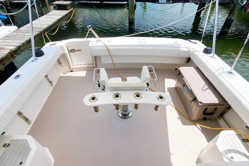 Slide: The Image of 1997 Albemarle 30 Express boat deck with fishing chair and storage compartments. - 11