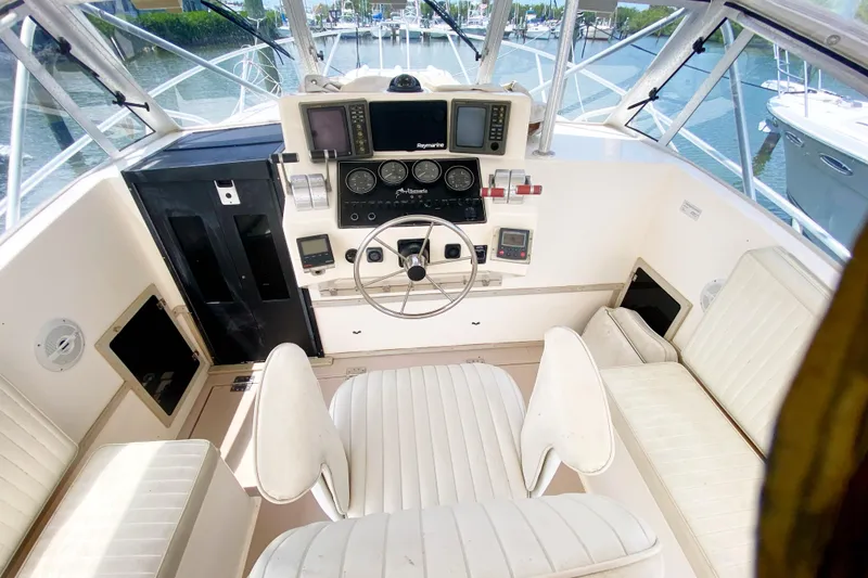 Slide: The Image of 1997 Albemarle 30 Express boat cockpit with steering wheel and navigation equipment. - 13