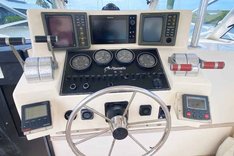 Slide: The Image of Control panel of a 1997 Albemarle 30 Express boat with steering wheel and gauges. - 15