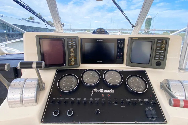 Slide: The Image of 1997 Albemarle 30 Express boat dashboard with navigation instruments and controls. - 16