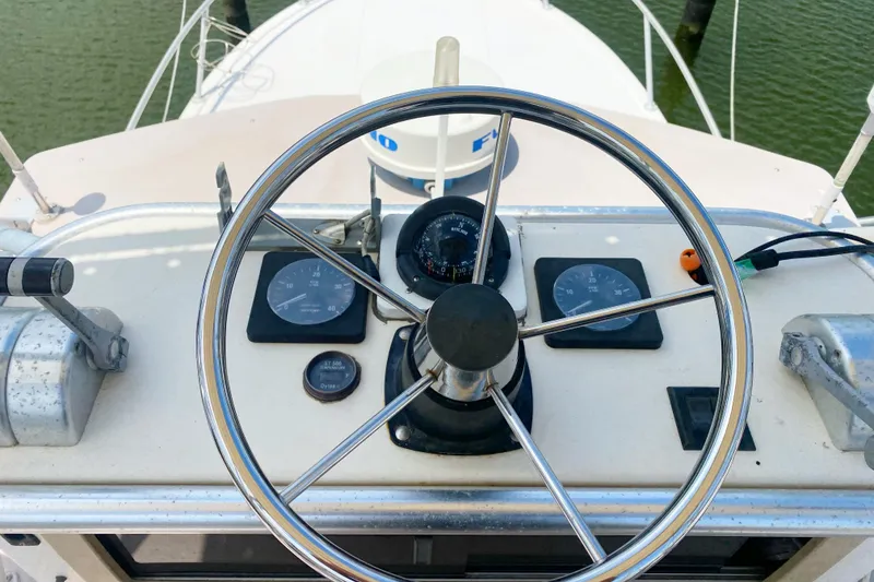 Slide: The Image of Steering wheel and gauges of a 1997 Albemarle 30 Express boat cockpit. - 22