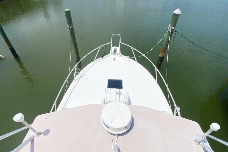 Slide: The Image of Bow view of a 1997 Albemarle 30 Express boat docked in calm waters. - 23