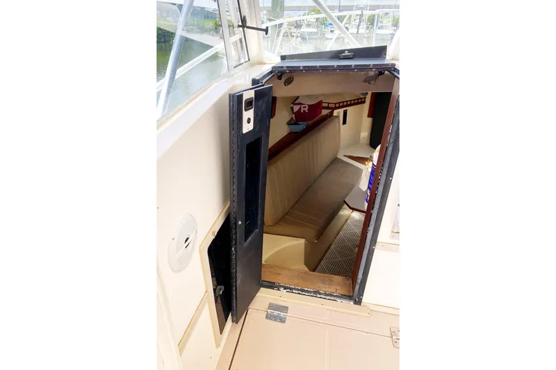 Slide: The Image of 1997 Albemarle 30 Express cabin entrance with seating and interior view. - 24