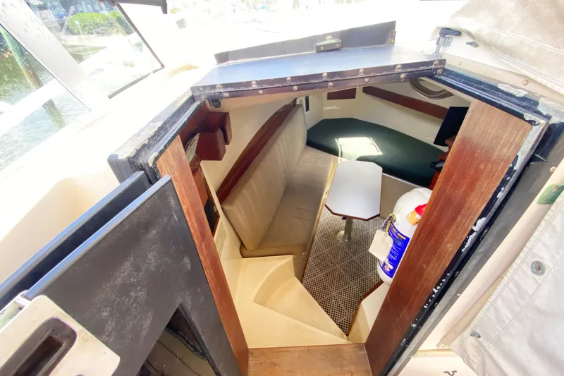 Slide: The Image of Interior cabin of a 1997 Albemarle 30 Express boat, featuring seating and a small table. - 25