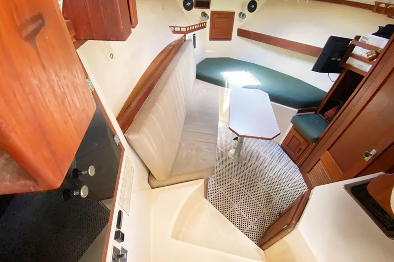 Slide: The Image of Interior of 1997 Albemarle 30 Express boat with seating, table, and wood accents. - 26