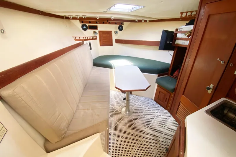 Slide: The Image of Interior of 1997 Albemarle 30 Express boat with seating, table, and storage. - 27