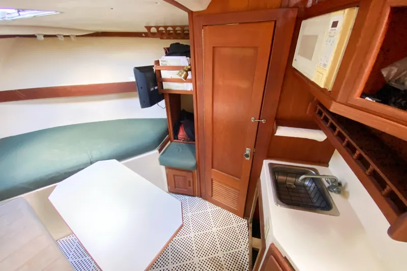 Slide: The Image of Interior of 1997 Albemarle 30 Express boat with kitchenette and seating area. - 29