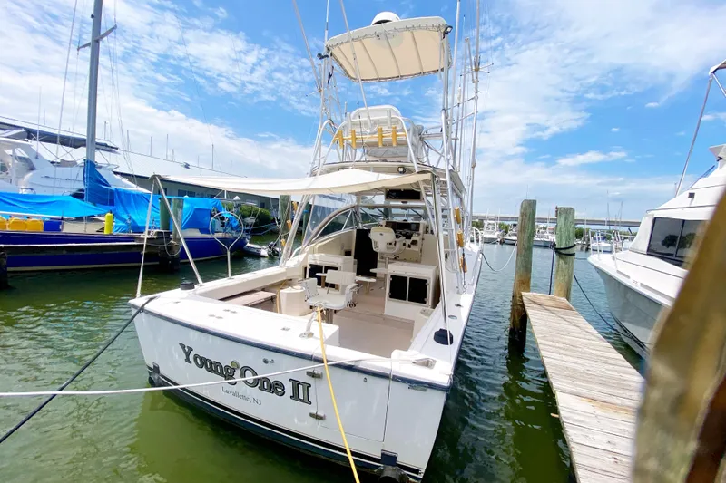 Slide: The Image of 1997 Albemarle 30 Express boat docked at marina under clear blue sky. - 3