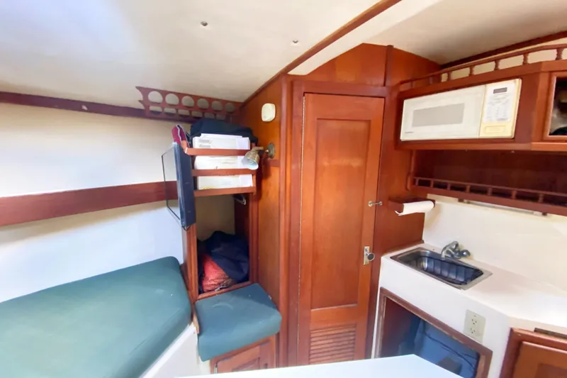 Slide: The Image of Interior of 1997 Albemarle 30 Express boat with kitchenette and storage. - 30