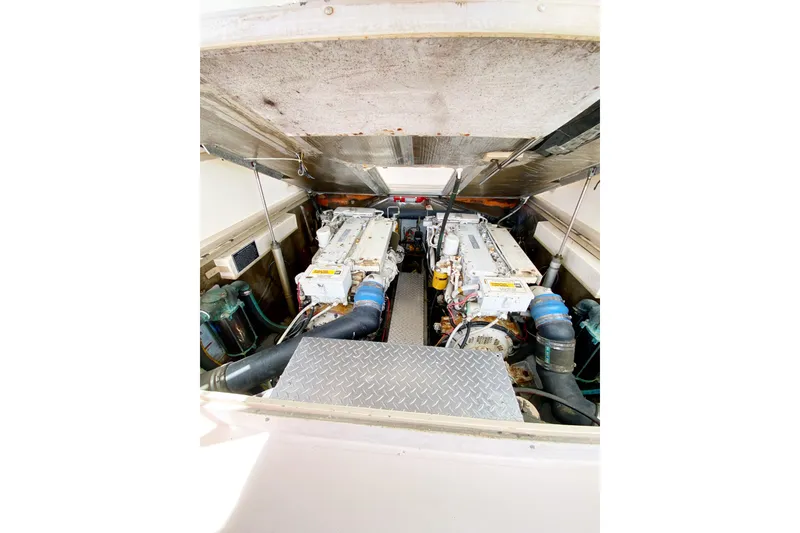 Slide: The Image of Engine compartment of a 1997 Albemarle 30 Express boat, showcasing dual engines. - 33