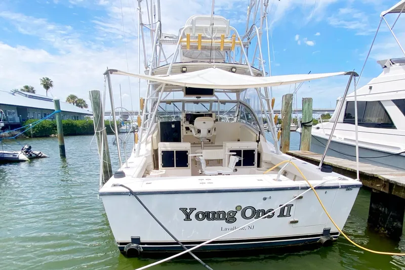 Slide: The Image of 1997 Albemarle 30 Express boat docked, featuring open cockpit and fishing equipment. - 4