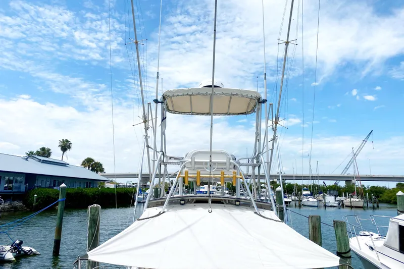 Slide: The Image of 1997 Albemarle 30 Express boat docked at marina under blue sky. - 6