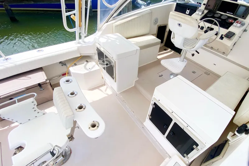 Slide: The Image of 1997 Albemarle 30 Express boat interior with helm, seating, and fishing rod holders. - 7