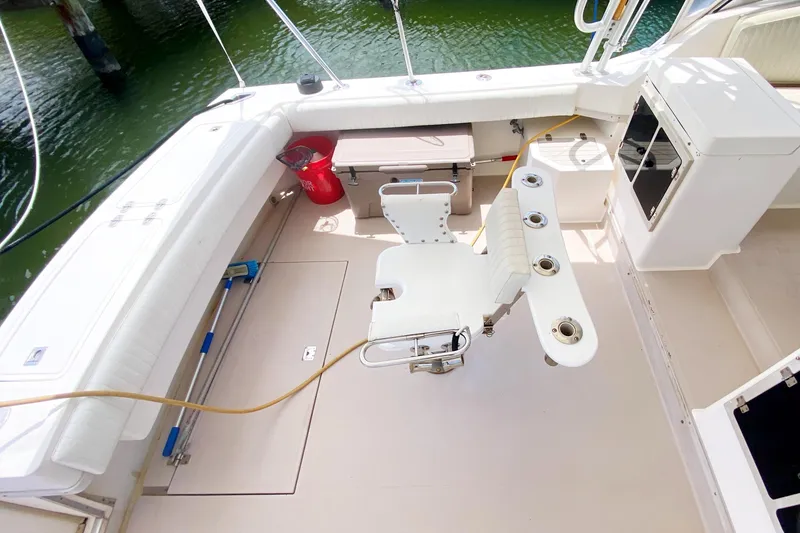 Slide: The Image of 1997 Albemarle 30 Express boat deck with fishing chair and rod holders. - 8