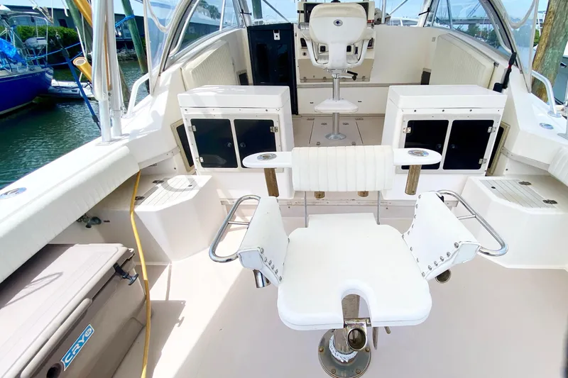 Slide: The Image of 1997 Albemarle 30 Express boat interior with seating and storage compartments. - 9