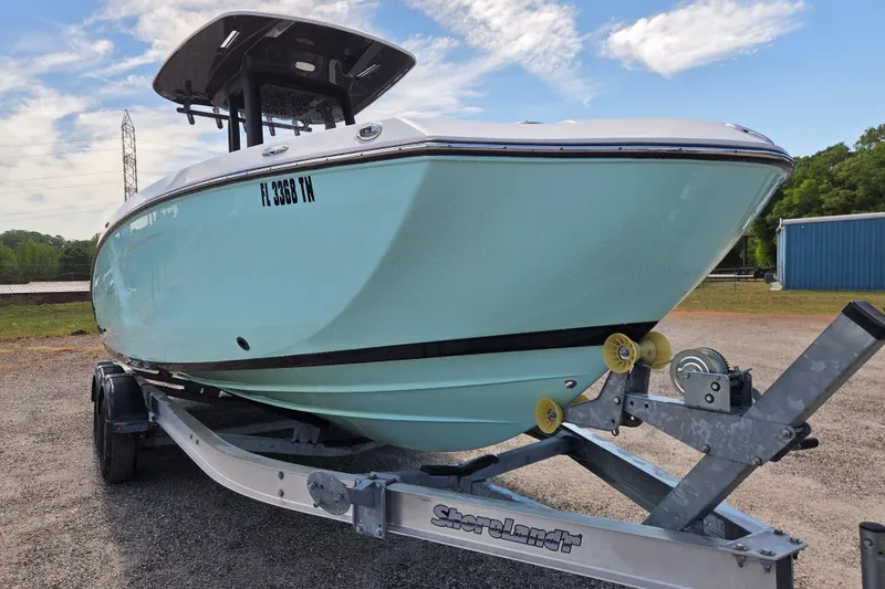 Slide: The Image of 2023 Yamaha Boats 255 FSH Sport E on trailer, side view. - 2