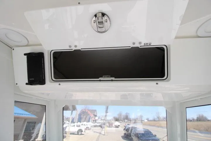 Slide: The Image of 2026 Sea Fox 228 Commander boat interior storage compartment with latch and speaker. - 11