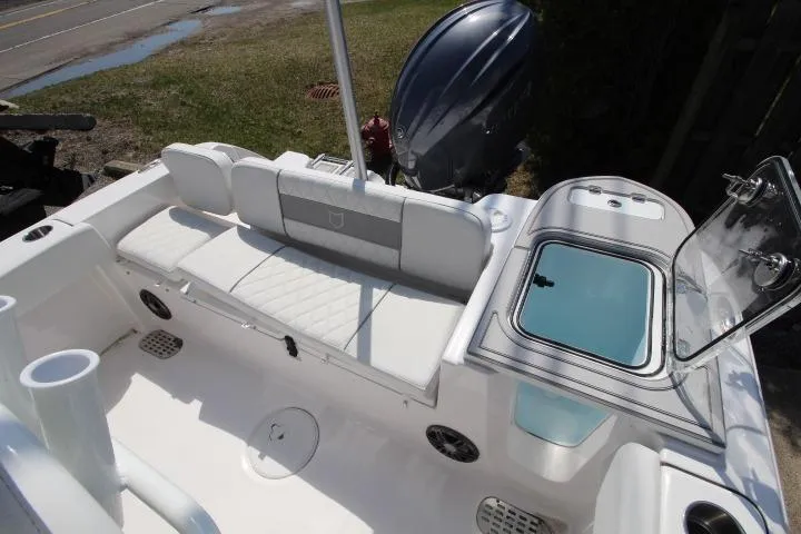 Slide: The Image of 2026 Sea Fox 228 Commander boat interior with seating and open storage compartment. - 16