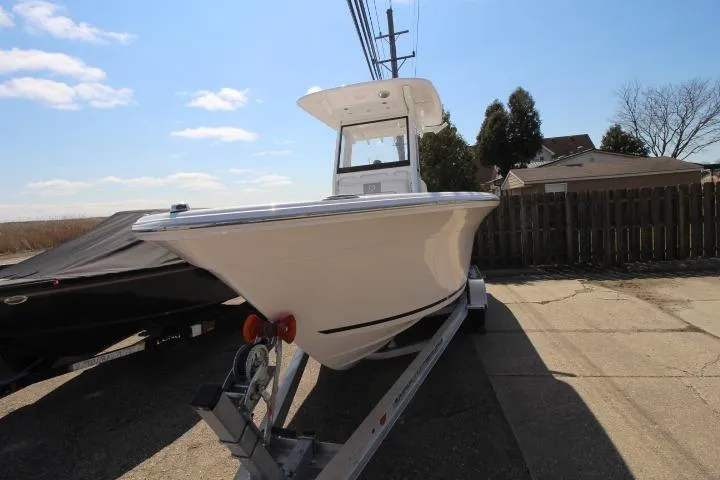 Slide: The Image of 2026 Sea Fox 228 Commander boat on trailer, parked outdoors under a clear sky. - 2