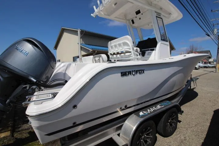 Slide: The Image of 2026 Sea Fox 228 Commander boat on trailer, featuring Yamaha engine, parked outdoors. - 4