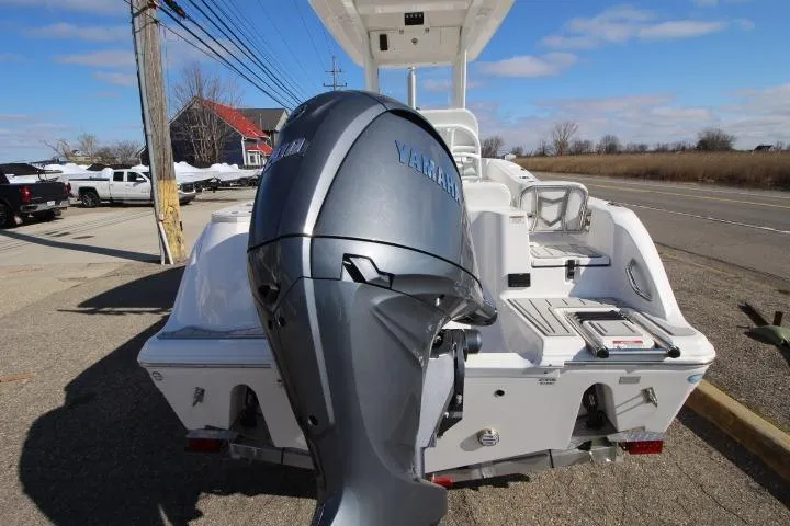 Slide: The Image of 2026 Sea Fox 228 Commander boat with Yamaha outboard motor, parked on a sunny day. - 5