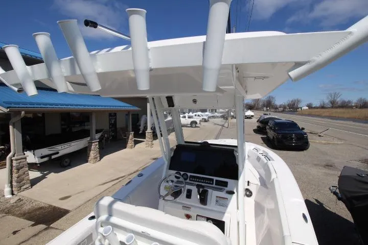 Slide: The Image of 2026 Sea Fox 228 Commander boat with T-top and console, parked near dealership. - 8