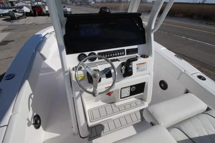 Slide: The Image of 2026 Sea Fox 228 Commander boat cockpit with steering wheel and control panel. - 9