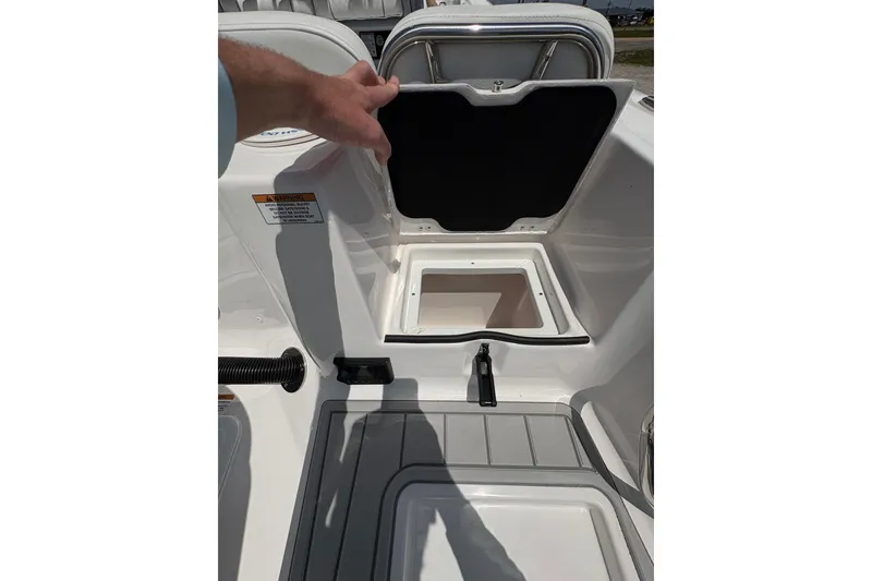 Slide: The Image of 2026 Sea Fox 248 Commander boat with white cushioned seating, parked near dealership. - 14