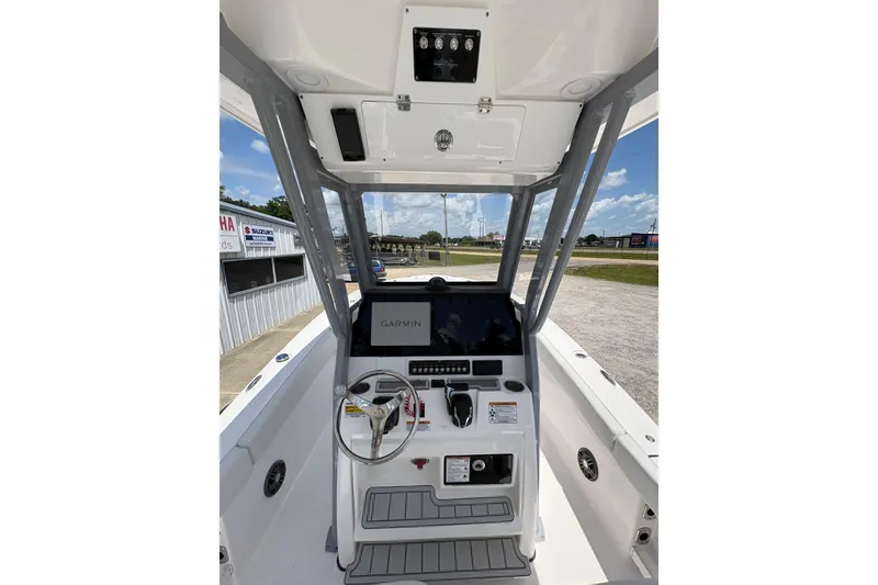 Slide: The Image of 2026 Sea Fox 248 Commander boat with Yamaha outboard motor, parked outdoors. - 4