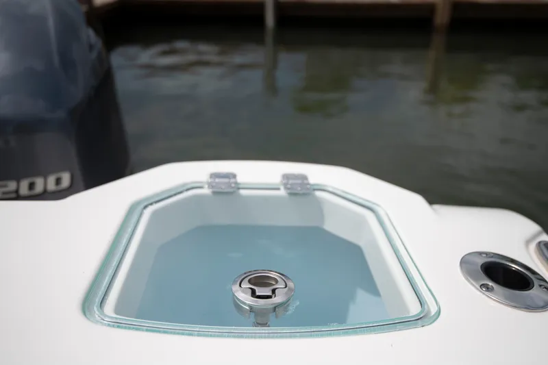 Slide: The Image of Livewell on 2027 Sailfish 272 CC boat, docked near water. - 18