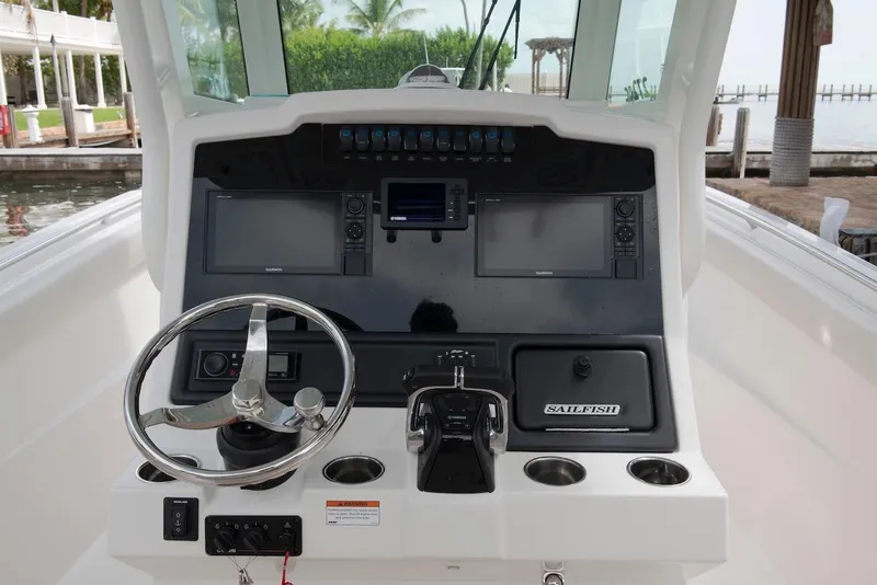 Slide: The Image of 2027 Sailfish 272 CC boat dashboard with steering wheel and navigation controls. - 8