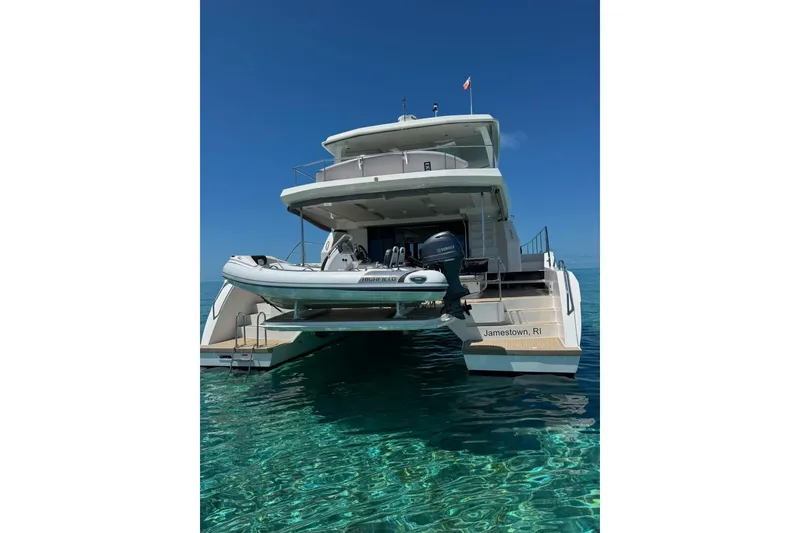 Slide: The Image of 2021 Leopard 53 Powercat yacht on clear water, rear view with tender boat. - 5
