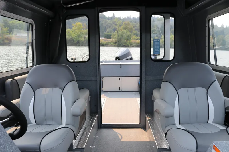 Slide: The Image of Interior of 2026 KingFisher 2425 Escape HT boat with comfortable seating and scenic water view. - 13