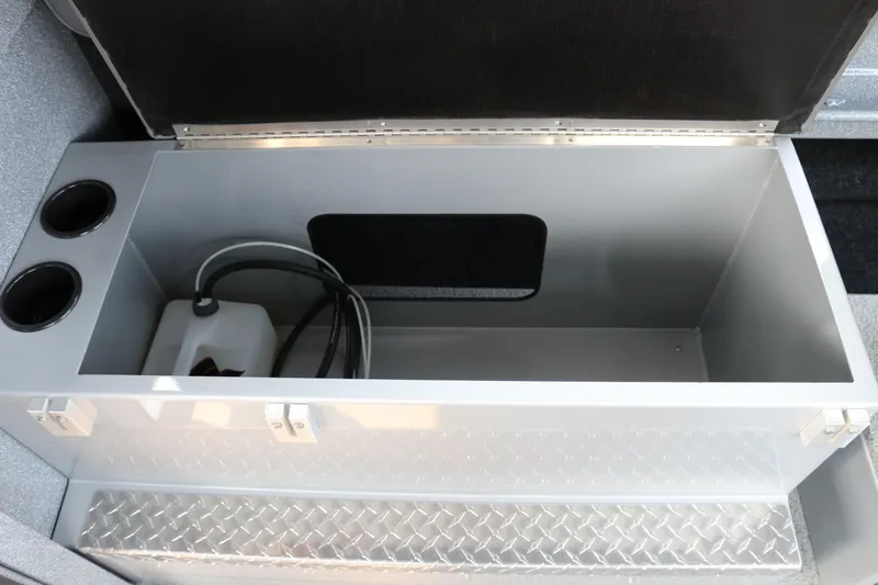 Slide: The Image of Storage compartment in 2026 KingFisher 2425 Escape HT boat, featuring cup holders and diamond plate flooring. - 16