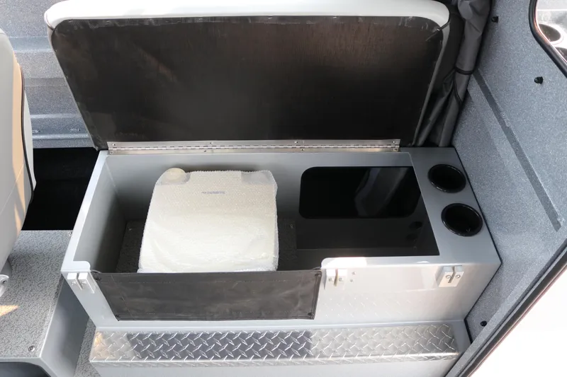 Slide: The Image of Storage compartment in 2026 KingFisher 2425 Escape HT boat, featuring cup holders and organized space. - 18