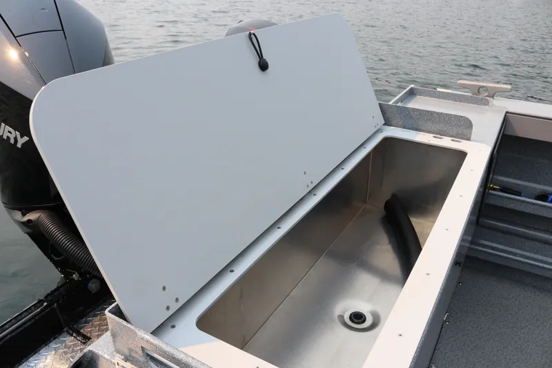 Slide: The Image of Open storage compartment on 2026 KingFisher 2425 Escape HT boat, near water. - 22