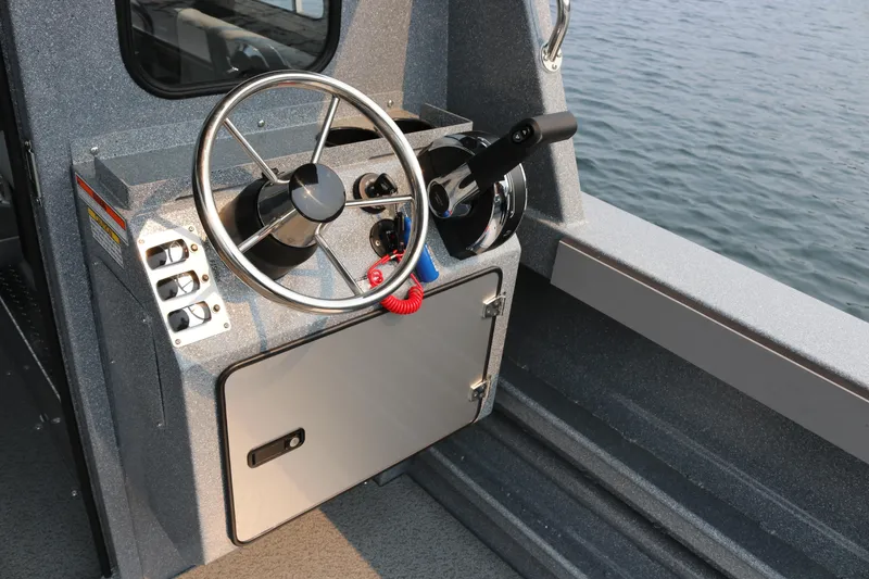 Slide: The Image of Steering console of 2026 KingFisher 2425 Escape HT boat by the water. - 23