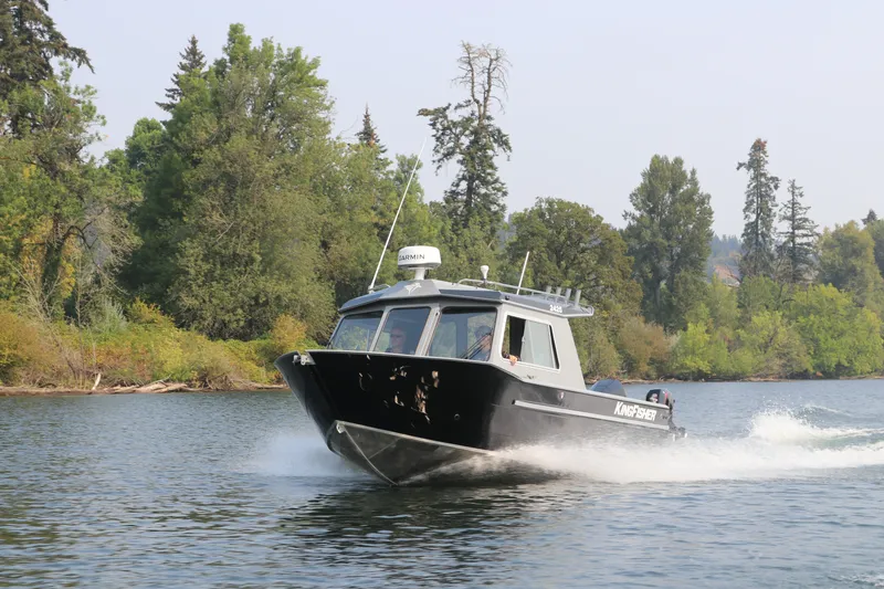 Slide: The Image of 2026 KingFisher 2425 Escape HT boat cruising on a scenic river. - 32