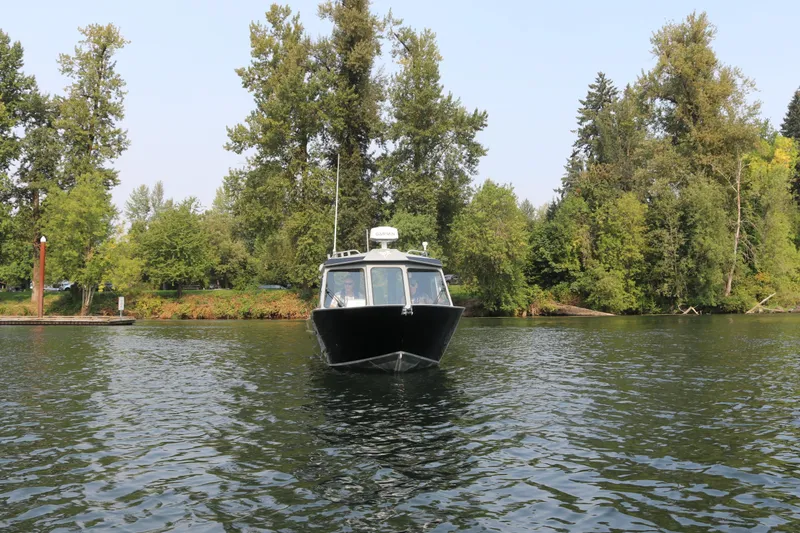 Slide: The Image of KingFisher 2425 Escape HT 2026 on a calm river with trees. - 33