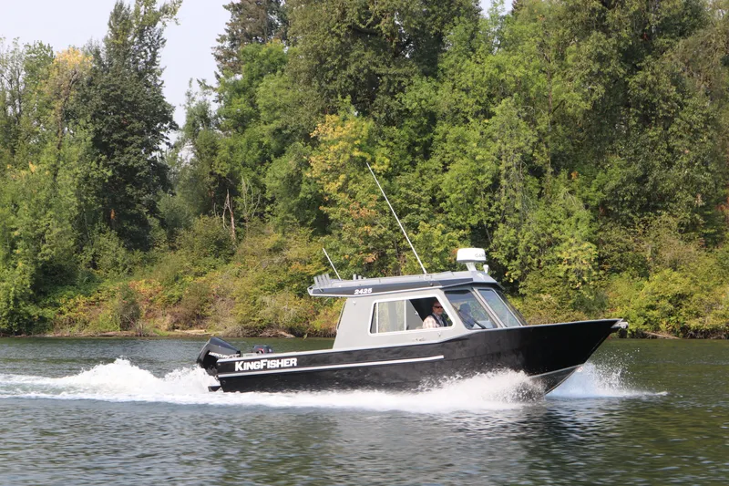 Slide: The Image of 2026 KingFisher 2425 Escape HT boat cruising on a scenic river. - 35