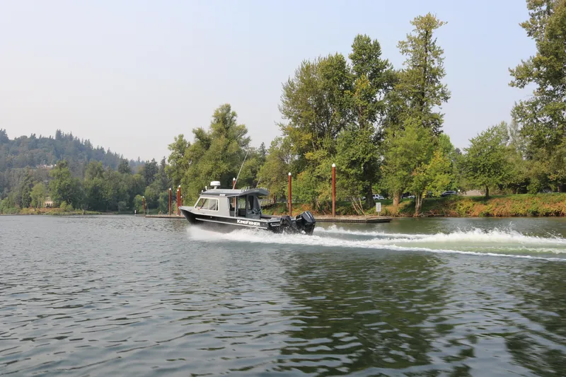 Slide: The Image of 2026 KingFisher 2425 Escape HT cruising on a scenic river with lush greenery. - 37