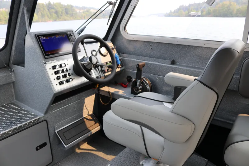 Slide: The Image of Interior of 2026 KingFisher 2425 Escape HT boat, featuring helm and seating. - 6