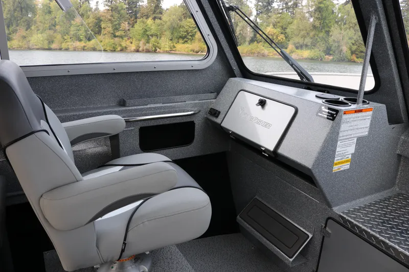 Slide: The Image of Interior of 2026 KingFisher 2425 Escape HT boat, featuring a comfortable captain's chair and control panel. - 8